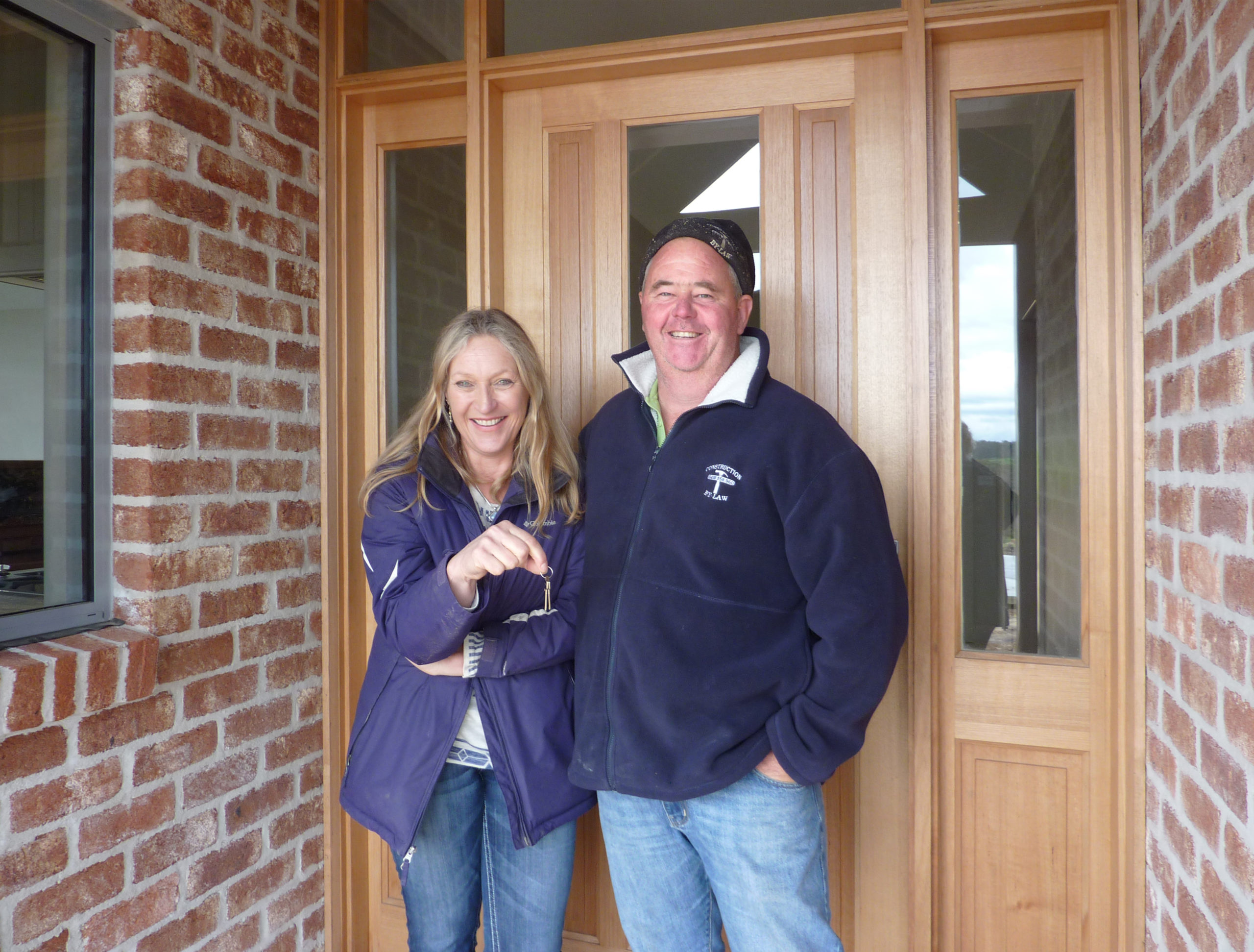 The Home owner Silvia, standing outside the front door with Doug the builder during handover of the property